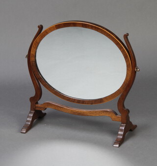 A Georgian style oval plate dressing table mirror contained in a mahogany swing frame 43cm h x 21cm w x 40cm d 