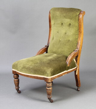 A Victorian mahogany show frame nursing chair upholstered in green buttoned material, raised on turned supports (frame loose) 