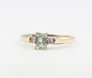 A 9ct yellow gold aquamarine and diamond ring 1.6 grams, size O