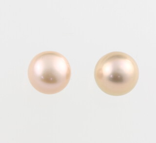 A pair of pink cultured pearl ear studs with 9ct yellow gold mounts 