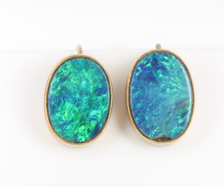 A pair of yellow gold and black opal oval earrings 15mm x 10cmm  