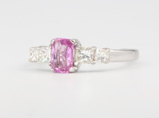 An 18ct white gold pink sapphire and diamond ring, centre stone approx. 0.45ct, princess cut diamond shoulders 0.5ct, size L 