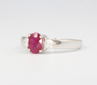 An 18ct white gold oval ruby and diamond ring, the centre stone approx. 1ct, diamonds 0.13ct, size M 