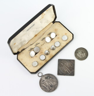 A cased silver and mother of pearl stud set, 3 commemorative medallions