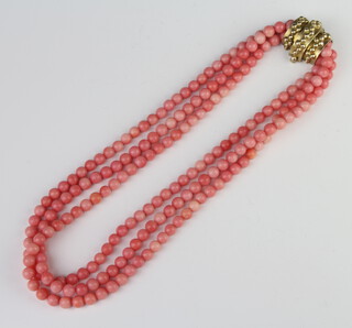 A string of 3 coral coloured beads with a silver gilt clasp 42cm 