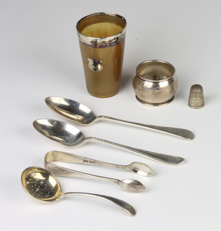 A silver mounted horn beaker, 3 spoons, a pair of sugar tongs, napkin ring and thimble, weighable silver 134 grams 