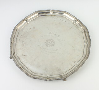 A silver engraved salver with presentation inscription, raised on pad feet Sheffield 1942, 30cm, 770 grams