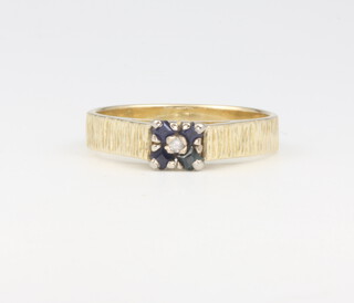 An 18ct yellow gold bark finish sapphire and diamond ring 3.9 grams, size M 1/2