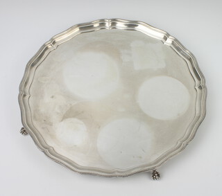 A silver salver with Chippendale rim on claw and ball feet Birmingham 1936, 35cm, 1360 grams 