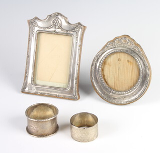 A silver napkin ring Birmingham 1933, 1 other and 2 repousse silver photograph frames Birmingham 1906 and 1913, 62 grams