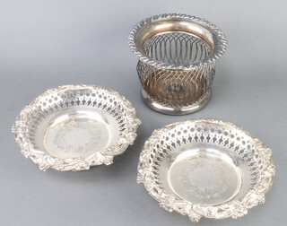 A pair of Victorian plated coasters with vinous rims and pierced borders 21cm, together with a wire work champagne coaster 17cm 
