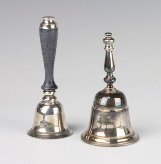 A silver hand bell London 1975 together with a ditto with wooden handle, gross 210 grams 
