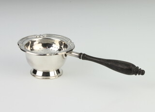 A silver tea strainer with turned wooden handle and stand, Birmingham 1984, 64 grams