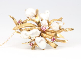 A 14ct yellow gold baroque pearl and ruby open scroll brooch 16.8 grams, 55mm x 35mm 