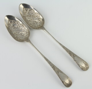 A matched pair of George III silver berry spoons with floral decoration, London 1809 and 1811, 126 grams 
