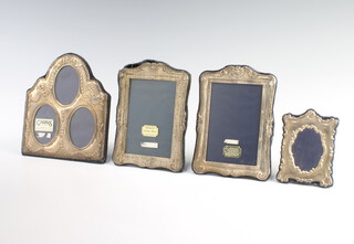 A pair of modern repousse silver photograph frames 15cm and 2 others 