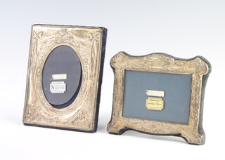 A modern repousse silver photograph frame 13cm and 1 other 