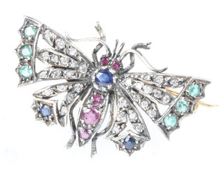 A silver gilt novelty butterfly brooch set with diamonds, rubies, sapphires and emeralds 40mm, 7.1 grams 