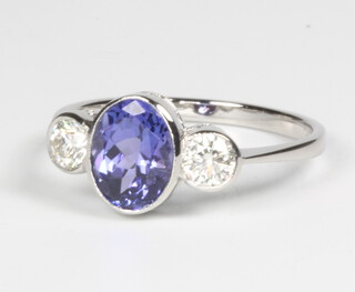 A platinum, tanzanite and diamond 3 stone ring, the centre stone approx. 1.3ct the 2 brilliant cut diamonds approx. 0.4ct, size N 1/2, 3.5 grams