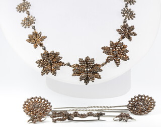 A suite of Victorian iron and steel jewellery comprising necklace, 2 hair pins, pair of earrings and a brooch 