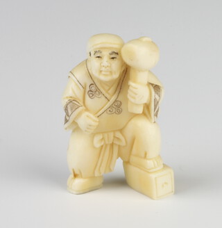 A Meiji period ivory Netsuke in the form of a standing gentleman with giant mallet, signed 5cm 