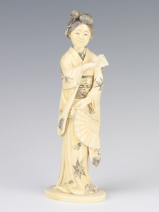 A Meiji period Japanese carved ivory figure of a standing lady, signed, 19cm 