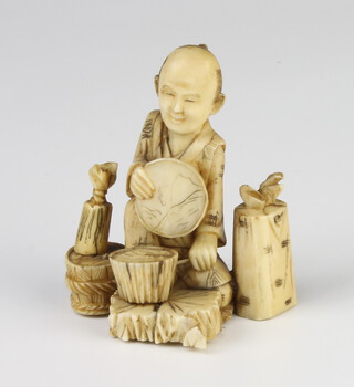 A carved ivory Okimono of a seated chef 5.5cm 