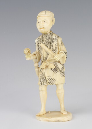 A Japanese Meiji period carved Okimono of a standing gentleman 15.5cm 