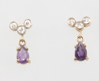 A pair of 9ct yellow gold pear cut amethyst and diamond ear studs, the amethysts approx. 0.5ct, the 6 diamonds approx. 0.20ct, 1.1 grams