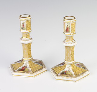 A pair of 19th Century German hexagonal candlesticks decorated with panels of figures 14cm 