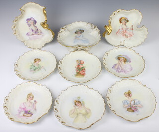A Limoges dessert service decorated with ladies at pursuits comprising 6 plates, 2 scallop shaped dishes and a tazza, all signed M Dare 1912 