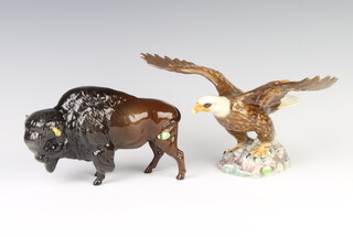A Beswick figure of a bald eagle no.1018, brown and white gloss 18.4cm, together with a ditto bison 1019 brown gloss 14.6cm, both modelled by Arthur Greddington