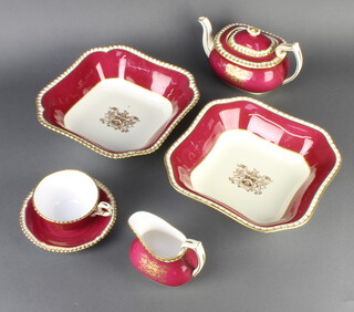 A Spode bone china part tea set, the burgundy and gilt decoration with the crest of The Worshipful Company of Cloth Makers comprising teapot, 4 tea cups, 4 saucers, 3 milk jugs, dish, 4 small plates, 4 square bowls, 1 sugar bowl