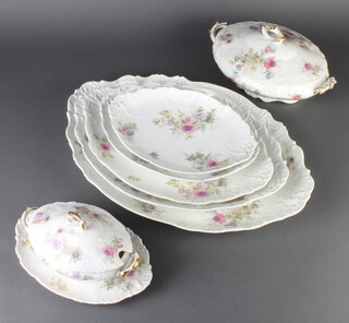 A Limoges dinner service decorated with spring flowers comprising 12 dinner plates, 10 medium plates, 11 small plates, 2 small tureens and stands, 2 large tureens (1 without lid), 2 stands, 3 oval dishes 