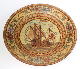 A Portuguese ceramic charger decorated with a galleon enclosed in a floral border 38cm 