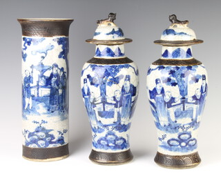 A pair of Chinese crackle glazed oviform vases and covers decorated with figures in gardens 37cm together with a matching vase with flared neck 36cm 
