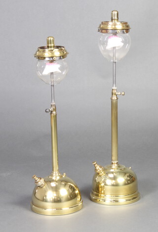 Two brass tilley lamps complete with glass shades 56cm x 19cm 