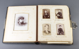 A Victorian leather bound photograph album containing black and white photographs 