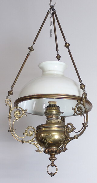 A Victorian gilt metal hanging oil lamp with an associated opaque glass shade 100cm h x 45cm diam.  