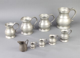 A set of 8 19th Century baluster shaped pewter measures comprising half gallon, quart, spouted quart, pint, half pint, gill, half gill, quarter gill, all marked with crown, Tudor rose mark and an X together with an Edwardian Art Nouveau cream jug base marked L and F Cole Cambridge Osiris 457 8cm 