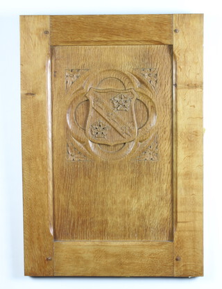 A rectangular carved oak panel with armorial decoration 64cm x 45cm x 3cm 