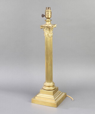 J Hinks & Sons, a Victorian brass reeded column table lamp with Corinthian capital on a stepped base marked J Hinks & Sons 1782, later converted to electricity 50cm x 16cm x 16cm 
