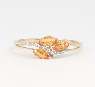 A 9ct yellow gold fire opal and diamond crossover ring, 2.2 grams, size U 