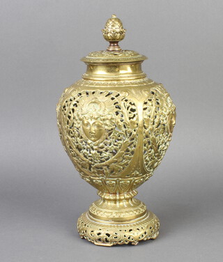 A Victorian pierced brass urn shaped incense burner raised on a circular foot 26cm h x 12cm diam. 