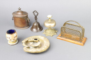 An Edwardian oak and brass twin division letter rack 11cm x 15cm x 7cm, a bronze table bell, 1 other bell, a Georgian style oval lidded caddy with hinged lid 13cm x 9cm x 7cm, brass ashtray in the form of a horseshoe 14cm x 13cm and a Royal Doulton salt glazed match striker 7cm x 5cm 