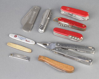 A Victorinox folding multi tool incorporating a rule, pliers and screwdriver, a Sandvik folding knife, a Victorinox folding knife with blade marked Switzerland, 3 Swiss Army pen knives and other knives 