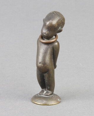 A bronze seal in the form of a standing child base marked WHM 5cm x 1cm