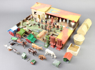 A collection of Britains lead farmyard figures, haystacks, animals etc, contained within a wooden farm 