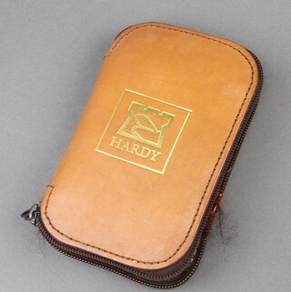 A Hardy Bros. leather fly wallet 15cm x 10cm containing fishing flies 