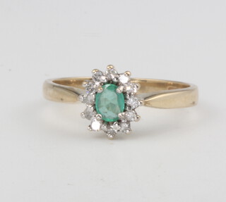 A 9ct yellow gold oval emerald and diamond cluster ring 1.7 grams, size L 